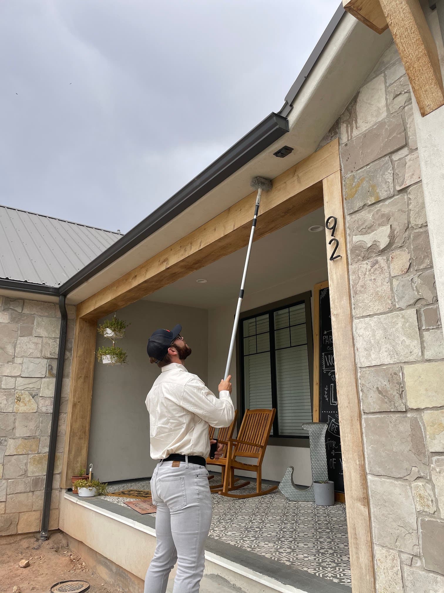 Bugman technician treating eaves